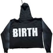 A picture of EXCLUSIVE Black Crop Hoodie with a design that shows 'BIRTH' on the back