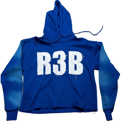 A picture of EXCLUSIVE  Blue Crop Hoodie with a design that shows 'R3B'