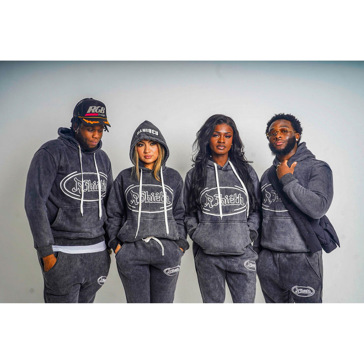 four people wearing a black acid washed hoodie with a design that shows the R3Birth logo