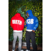 Two man wearing crop hoodies with design that shows "R3B" in front and "BIRTH" on back