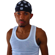 Man wearing a black skull cap with a design that shows the R3birth clothing logo