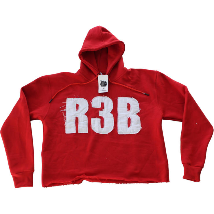 Picture of a red crop hoodie with a design that shows &